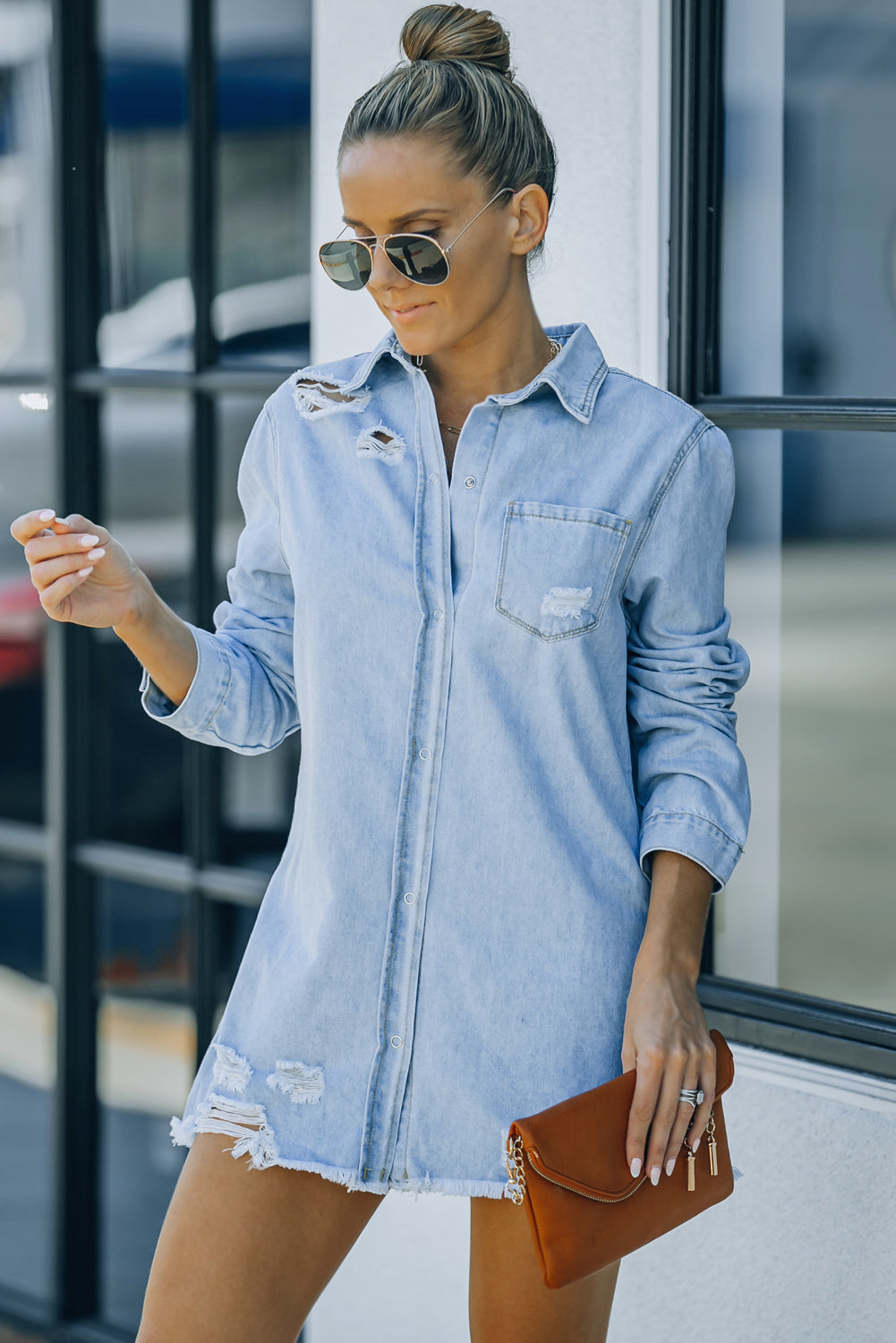 Woman in medium shade denim snap down jacket