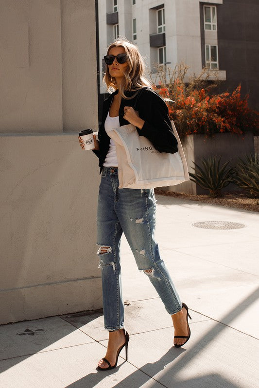 Woman with Jeans and Tshirt walking down the street