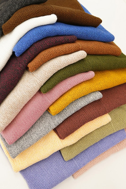 Stack on multi colored sweaters