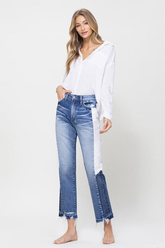 Woman in Jeans and blouse in front of white background 