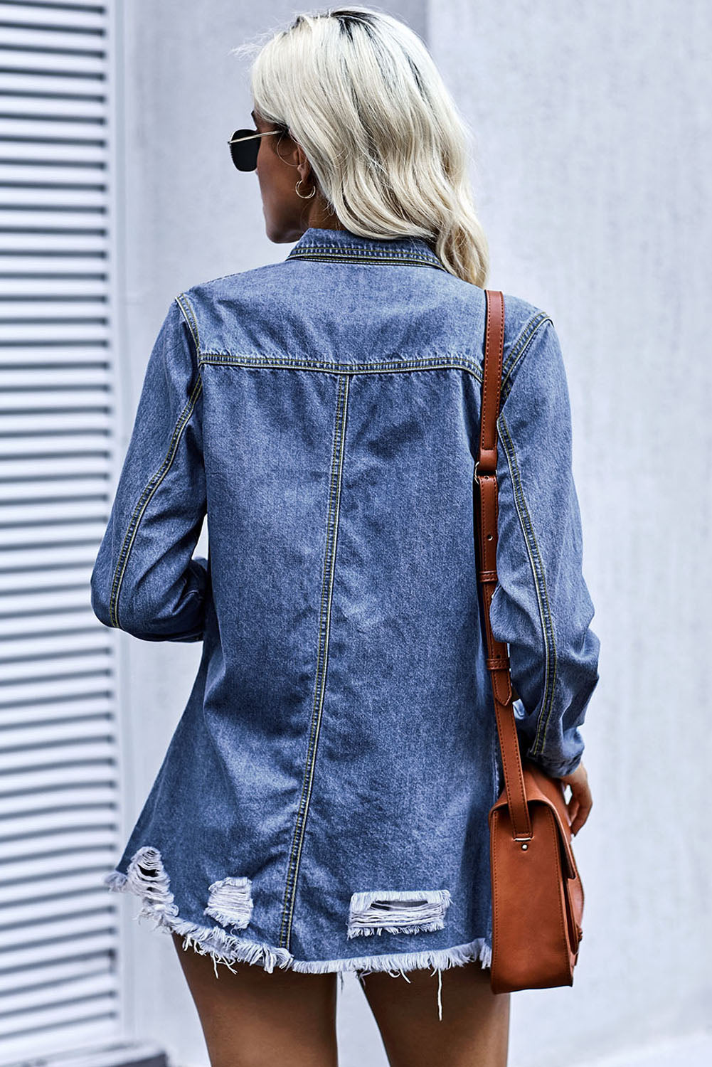 Woman in medium shade denim snap down jacket