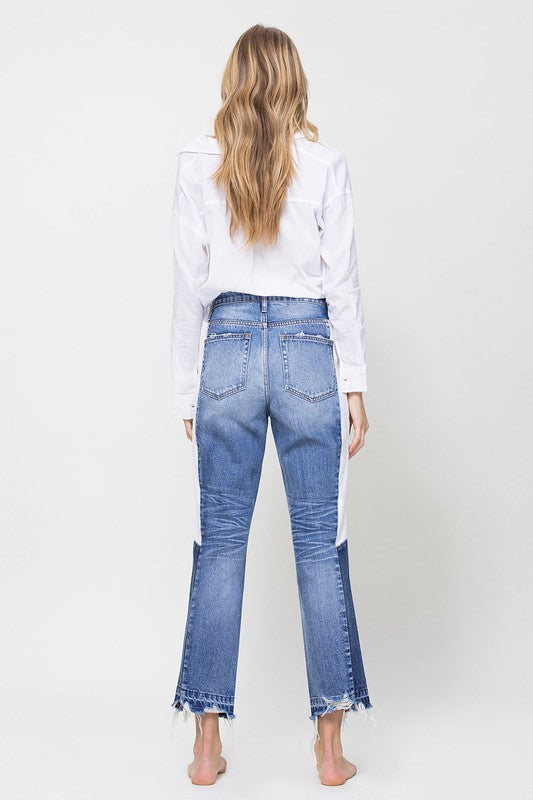 Woman in Jeans and blouse in front of white background 