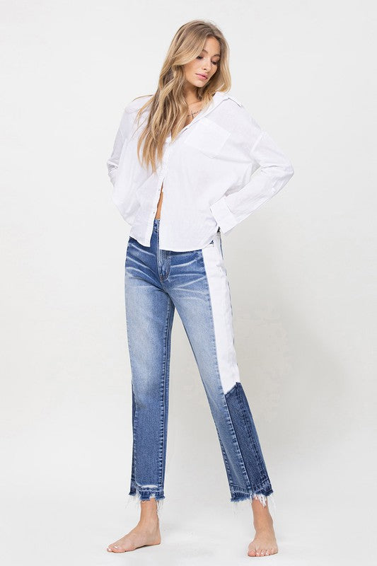 Woman in Jeans and blouse in front of white background 