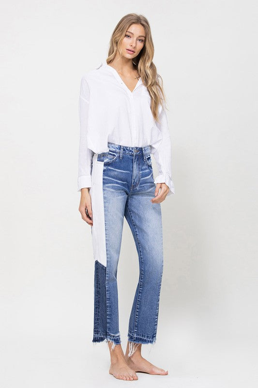 Woman in Jeans and blouse in front of white background 